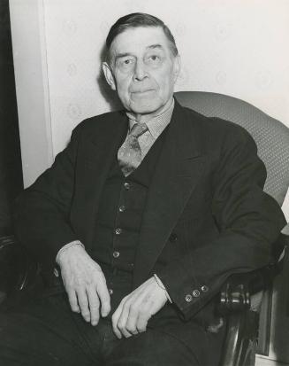 Jimmy Collins Sitting in Armchair photograph, possibly 1943