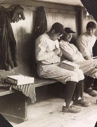 Babe Ruth Signing Baseball in Dugout photograph, between 1920 and 1934