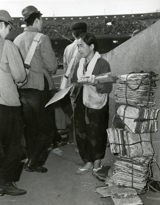 Japanese Woman Selling Seat Cushions photograph, 1947 April 27