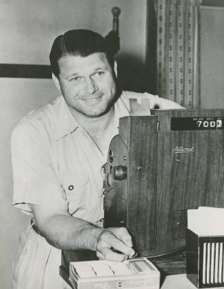 Jimmie Foxx Standing behind Cash Register photograph, between 1936 and 1942