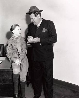 Babe Ruth Signing Autograph for Boy Scout photograph, 1943 April 11