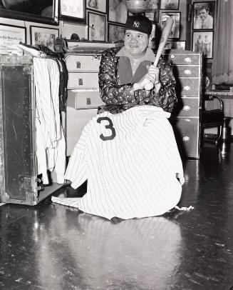 Babe Ruth Posing with Jersey at His Apartment photograph, 1942 January 31